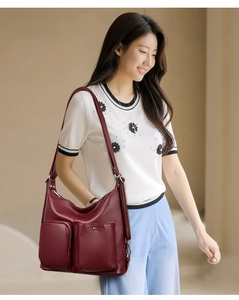 Detail view of burgundy soft leather hobo bag with zip pockets and adjustable strap