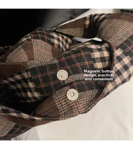 Detail shot of the vintage plaid shoulder bag featuring a convenient magnetic snap closure