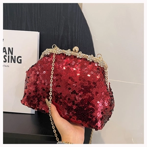 Detail of burgundy sequin evening bag with sparkling rhinestone flower clasp and chain
