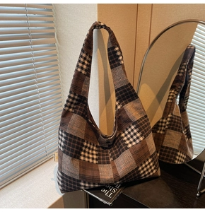Close-up of retro checkered hobo bag with thick canvas texture and wide shoulder strap