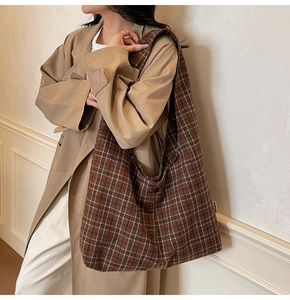 Detail view of large checkered shoulder bag with vintage brown and beige pattern