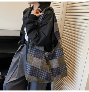 Detail of vintage plaid tote bag featuring checkered fabric and side button adjustment