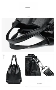 Detail view of lychee-textured black tote bag featuring reinforced handles and silver hooks