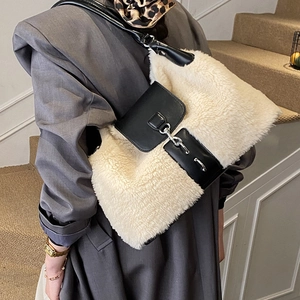 Women's faux fur crossbody bag in white and black leather shown on shoulder