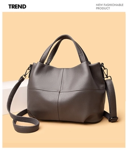 Detail of the dark grey lychee grain leather tote bag with cross-stitched design accents