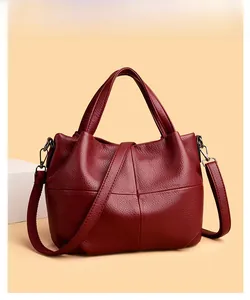 Close-up of wine red lychee pattern tote bag with cross-stitch details and metal hardware