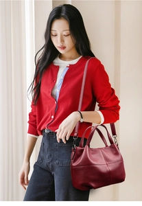 Close-up of vintage burgundy lychee leather tote with classic four-grid stitching detail