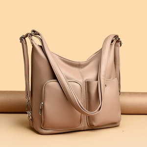 Taupe pebbled leather shoulder bag with functional front pockets and silver hardware detail