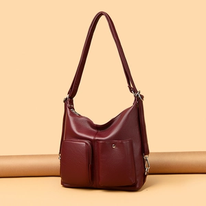 Burgundy faux leather shoulder bag with dual front pockets and litchi texture finish