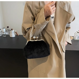 Détail du sac en fausse fourrure noire avec poignée en perles et fermoir en perles métal