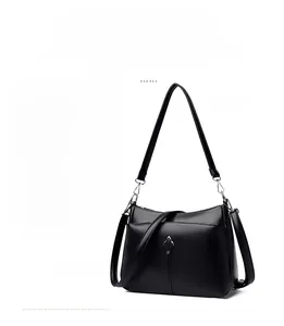 Detail of detachable silver hardware and lychee pattern leather on black shoulder bag