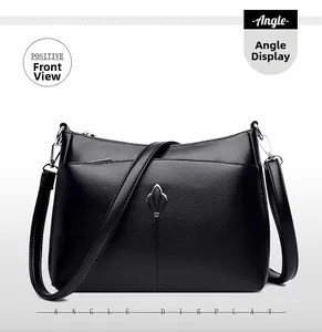 Close-up of black lychee-grain leather texture and silver rhombic hardware on the handbag