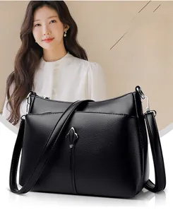 Detail of black pebbled leather texture and silver buckle on female shoulder bag
