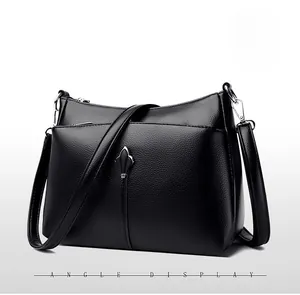 Side angle display of black pebbled leather handbag with double zippers and silver hardware