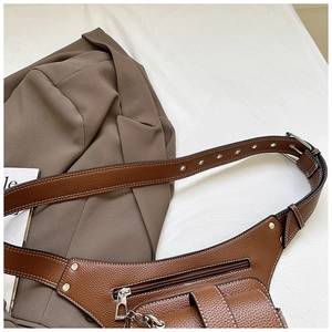 Detail of vintage brown lychee grain leather waist bag with silver metal hardware and stitching