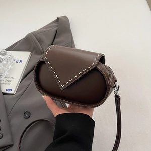 Brown leather crossbody bag with white V-stitching and adjustable shoulder strap