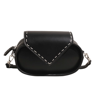 Minimalist black capsule crossbody bag with contrasting white handmade stitching