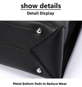 Detail of black lychee grain leather bag base with silver anti-wear metal feet studs