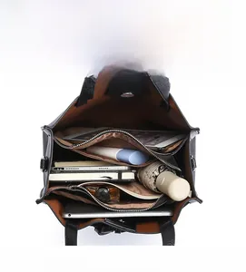 Interior view of black tote bag showing spacious compartments and brown lining for daily items