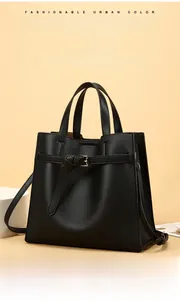 Detailed close-up of high-quality lychee pattern leather texture and metal buckle on black tote bag
