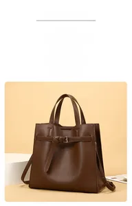 Close-up of brown litchi grain leather tote bag featuring silver metal buckle and strap