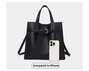 Detail of black lychee grain tote bag with size comparison to an iPhone mobile
