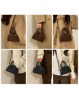 Detail of Boston-style handbag with bow dot embroidery and adjustable strap options