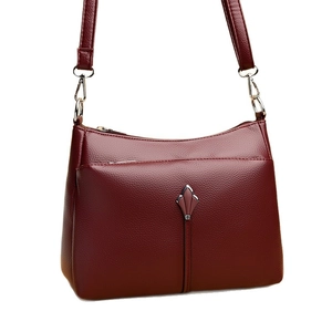 Elegant wine red leather handbag for women with pebble texture and silver shield hardware