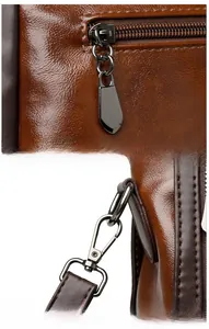 Detail of dark brown wax leather tote with gunmetal zipper and swivel snap hooks