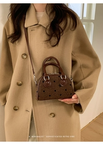 Polka dot mini tote bag paired with a camel wool coat for a sophisticated retro vibe