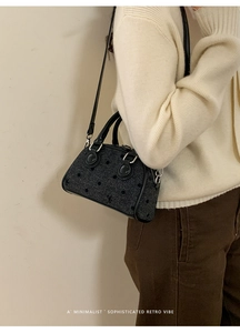 Close-up of retro black polka dot tweed crossbody bag with silver hardware detail