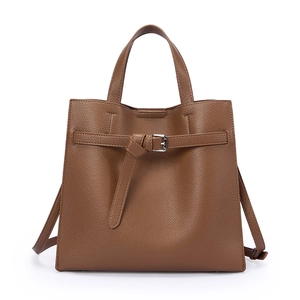 Minimalist soft leather tote bag in dark brown with pebble texture and knotted strap