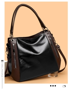 Detail of vintage oil-waxed black leather shell tote with brown contrast stitching