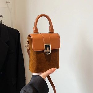 Vintage brown suede and leather crossbody bag with elegant gold metal lock clasp