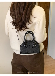 Close-up of retro polka dot wool crossbody bag with leather handle and silver hardware
