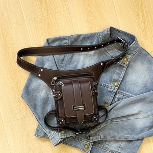 Vintage brown punk waist leg bag with metal rivets and chain on denim jacket