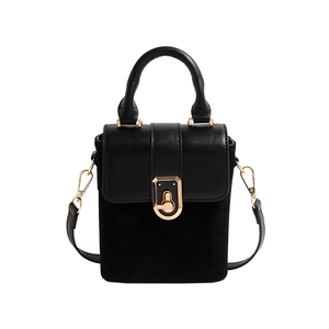 Minimalist black box bag in leather and suede with gold lock shown in center front view