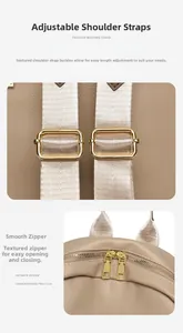 Detail of adjustable strap with gold hardware and smooth dual zippers on lychee leather bag