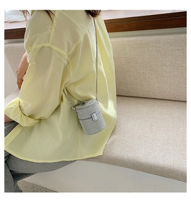 Silver cylinder chain bag shown on model for a trendy minimalist and aesthetic look