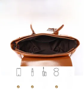 Internal view of brown leather tote bag showing large capacity for phone and cosmetics