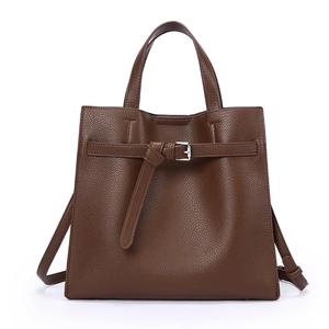 Minimalist dark brown soft leather tote bag with sturdy handles and adjustable strap