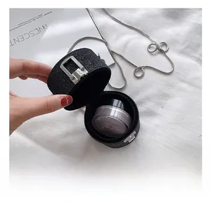 Detail view of mini round glitter bag interior showing space for makeup accessories