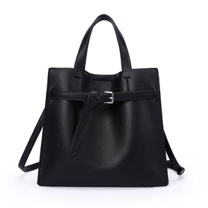 Minimalist black lychee leather tote bag with silver buckle and adjustable strap