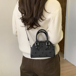 Chic dark gray polka dot crossbody bag with dual handles and silver metal hardware