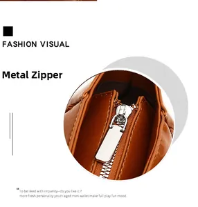 Detailed macro shot of the premium silver zipper hardware on a brown leather handbag