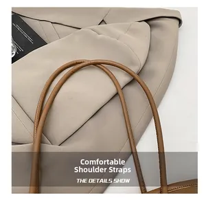 Detail of premium brown leather shoulder strap with fine stitching on a vintage tote bag