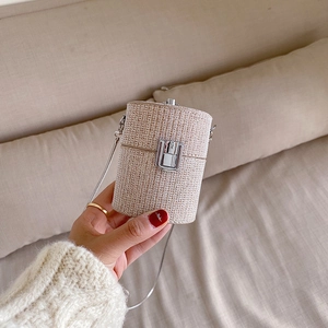 Chic beige straw mini cylinder shoulder bag with silver chain strap for women