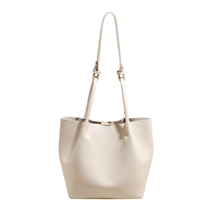 Minimalist off-white bucket bag in lychee pattern leather with adjustable shoulder strap
