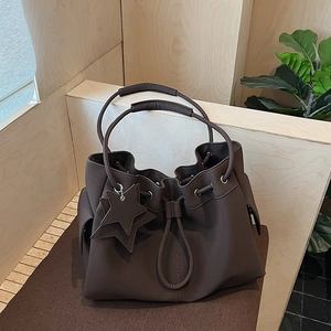 Minimalist dark brown drawstring bucket bag with star pendant and dual handles