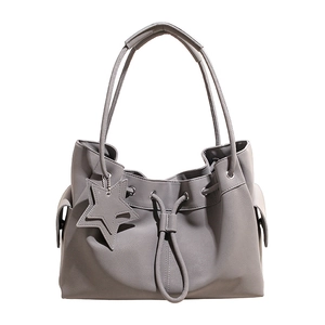 Minimalist grey faux leather tote bag with star charm and drawstring detail for women